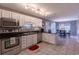 Well-lit kitchen boasts white cabinets, stainless steel appliances, and flows into the dining area at 8091 Bark Ct., Murrells Inlet, SC 29576