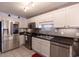 Modern kitchen with stainless steel appliances, white cabinets, and dark countertops at 8091 Bark Ct., Murrells Inlet, SC 29576