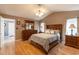 Spacious primary bedroom with vaulted ceilings, wood-look floors, and ensuite bathroom at 8091 Bark Ct., Murrells Inlet, SC 29576