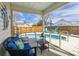 Relaxing screened-in patio with cozy seating overlooking a refreshing private pool at 8091 Bark Ct., Murrells Inlet, SC 29576