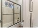 Bright bathroom features shower-tub combo with glass door and picture window at 8285 Leone Circle, Myrtle Beach, SC 29579