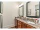 Bathroom features double vanity with granite counters and framed mirrors at 8285 Leone Circle, Myrtle Beach, SC 29579