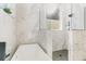 Bright bathroom with a soaking tub and a stand-up shower with marble tile at 8285 Leone Circle, Myrtle Beach, SC 29579