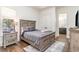 Cozy bedroom boasts wood floors, neutral color palette, and ensuite bathroom at 8285 Leone Circle, Myrtle Beach, SC 29579