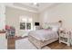 Bright bedroom boasts a large window and hardwood floors at 8285 Leone Circle, Myrtle Beach, SC 29579