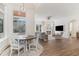 Sunlit dining area adjoining a comfortable living room with wood floors and large windows at 8285 Leone Circle, Myrtle Beach, SC 29579