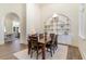 This dining room features wood floors, a built-in shelving unit, and a dining table with six chairs at 8285 Leone Circle, Myrtle Beach, SC 29579