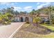 Beautiful home with a red roof and a circular driveway surrounded by lush landscaping at 8285 Leone Circle, Myrtle Beach, SC 29579