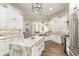 Bright kitchen boasts white cabinets, granite counters, an island, and stainless steel appliances at 8285 Leone Circle, Myrtle Beach, SC 29579