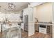 Well-lit kitchen features stainless steel appliances, granite counters, white cabinets, and a pantry at 8285 Leone Circle, Myrtle Beach, SC 29579
