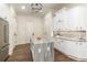 Stylish kitchen island with granite countertop, stainless steel refrigerator, and white cabinets at 8285 Leone Circle, Myrtle Beach, SC 29579