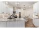 Modern kitchen with white cabinets, stainless steel appliances, and a gray granite countertop at 8285 Leone Circle, Myrtle Beach, SC 29579