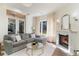 Comfortable living room with a fireplace, large windows, and a view of the landscaped yard at 8285 Leone Circle, Myrtle Beach, SC 29579
