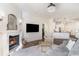 Elegant living room featuring a marble fireplace, TV, and an open doorway to the kitchen at 8285 Leone Circle, Myrtle Beach, SC 29579