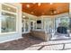 Covered outdoor patio with ceiling fans, brick floors, and comfortable seating at 8285 Leone Circle, Myrtle Beach, SC 29579