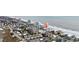 Breathtaking aerial view of a coastal community with oceanfront condos and charming beach houses at 900 N Waccamaw Dr. # 303, Murrells Inlet, SC 29576