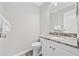 Cozy powder room featuring a granite countertop, toilet, white cabinets, and soft towels at 900 N Waccamaw Dr. # 303, Murrells Inlet, SC 29576