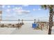 Beach access with a wooden walkway, beach rules sign, and dunes leading to a tranquil ocean view under a sunny sky at 900 N Waccamaw Dr. # 303, Murrells Inlet, SC 29576