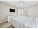 This is a bedroom with light walls, a fan, and a television, complete with a closet and adjacent doorway at 900 N Waccamaw Dr. # 303, Murrells Inlet, SC 29576