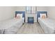 Cozy bedroom featuring two twin beds with beach themed pillows at 900 N Waccamaw Dr. # 303, Murrells Inlet, SC 29576