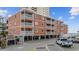 Beach condo building featuring multiple units with balconies overlooking the ocean and parking at 900 N Waccamaw Dr. # 303, Murrells Inlet, SC 29576