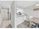 Modern kitchen with eat-in bar area featuring white cabinets, stainless appliances, and updated countertops at 900 N Waccamaw Dr. # 303, Murrells Inlet, SC 29576