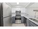 Updated kitchen featuring stainless steel appliances, white cabinets, and stone countertops at 900 N Waccamaw Dr. # 303, Murrells Inlet, SC 29576