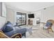 Comfortable living room with a couch, a TV, and access to the Primary bedroom and balcony at 900 N Waccamaw Dr. # 303, Murrells Inlet, SC 29576