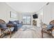 Relaxing living room with a comfortable sofa, a TV, and access to the outdoor balcony at 900 N Waccamaw Dr. # 303, Murrells Inlet, SC 29576