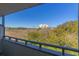 Balcony view overlooking scenic landscape with trees and a distant building against a clear blue sky at 9501 Shore Dr. # A-314, Myrtle Beach, SC 29572