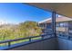 View from balcony looking out to tree tops and other buildings, under a clear blue sky at 9501 Shore Dr. # A-314, Myrtle Beach, SC 29572