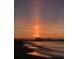 Serene beach view at sunset with a pier in the distance, perfect for evening strolls and relaxation at 9501 Shore Dr. # A-314, Myrtle Beach, SC 29572