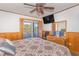 A bedroom with a queen-sized bed and a door to a screened porch at 9501 Shore Dr. # A-314, Myrtle Beach, SC 29572