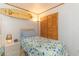 Cozy bedroom with a twin bed, surfboard decor and a window with blinds for privacy at 9501 Shore Dr. # A-314, Myrtle Beach, SC 29572