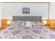 Cozy bedroom featuring a queen bed with a patterned comforter and matching bedside lamps at 9501 Shore Dr. # A-314, Myrtle Beach, SC 29572