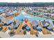Aerial view of a residential neighborhood showcasing a lovely home with a pond and manicured lawns at 982 Bonita Loop, Myrtle Beach, SC 29588