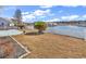 Landscaped backyard with a fence, well-manicured lawn, and a tranquil pond view at 982 Bonita Loop, Myrtle Beach, SC 29588