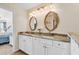 Double vanity with marble countertop, decorative mirrors, and ample cabinet space in a bright bathroom at 982 Bonita Loop, Myrtle Beach, SC 29588