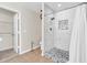 Modern bathroom featuring a walk-in shower with stylish stone flooring and white marble-patterned walls at 982 Bonita Loop, Myrtle Beach, SC 29588