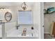 Bright bathroom highlighting a luxurious soaking tub, chandelier, and ample natural light at 982 Bonita Loop, Myrtle Beach, SC 29588