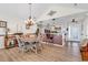 Open-concept dining area featuring wood floors, a brick-accented breakfast bar, and a decorative chandelier at 982 Bonita Loop, Myrtle Beach, SC 29588