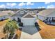 Home exterior featuring a two-car garage, a driveway, and tidy landscaping at 982 Bonita Loop, Myrtle Beach, SC 29588