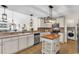 Well-lit kitchen with stainless steel appliances, island, and open floorplan with views to the living area at 982 Bonita Loop, Myrtle Beach, SC 29588