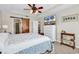 Main bedroom with a tray ceiling, ceiling fan, and sliding barn door access to bath at 982 Bonita Loop, Myrtle Beach, SC 29588