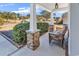 Cozy front porch with stone supports and wicker seating, inviting you to relax and enjoy the outdoors at 982 Bonita Loop, Myrtle Beach, SC 29588