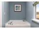 Clean bathroom with white soaking tub, decorative accents, and a large window at 104 Fair Meadow Ct., Loris, SC 29569