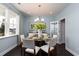 Cozy dining room with a round glass table, seating for four, and elegant light fixture at 104 Fair Meadow Ct., Loris, SC 29569