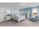 Relaxing main bedroom with a four-poster bed, neutral color palette, and sitting area at 104 Fair Meadow Ct., Loris, SC 29569