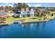 Aerial view of backyard with access to the lake, featuring a dock and lush greenery at 1042 Muscovy Pl., Conway, SC 29526