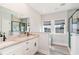 A contemporary bathroom featuring double sinks, granite countertops, a large mirror, a glass door shower, and tiled walls at 1042 Muscovy Pl., Conway, SC 29526